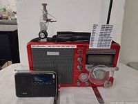 Front view of both radios; shows Eton S350DL controls and Grundig Traveler size comparison