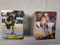 Two stacks of cards; front cards Cam Neely Fleer Ultra and Boston Bruins player on Leaf card