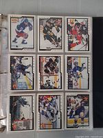 Binder page with nine Victory hockey cards showing various players