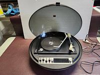 Unit with lid open showing platter and tone arm