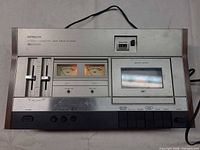 Front view of Hitachi D-2335 showing controls, VU meters, cassette door, wood side trim