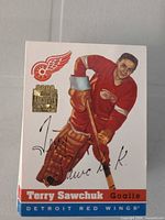 Close-up of Terry Sawchuk card showing Topps Archives 2002 foil stamp and autograph facsimile