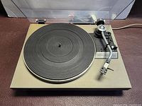 Top view showing entire Technics turntable with platter, tonearm and dust cover open
