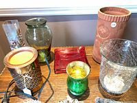 Group view of assorted vases, candle holders, red dish, terracotta vase, wax warmer