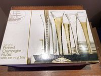 Retail box showing set of 6 etched champagne flutes with tray