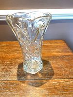 Full view of flared pressed glass vase standing on table