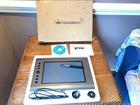 Tablet with pen, cable, pen stand, CD, manual in packaging insert