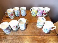 All ten assorted floral graphic mugs arranged on table