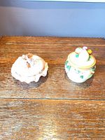 Front view of both trinket boxes closed on tabletop