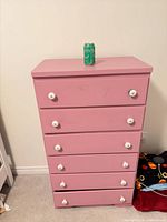 Front view of pink 6-drawer dresser with all drawers closed