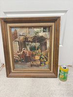 Front view of framed canvas print next to soda can for scale