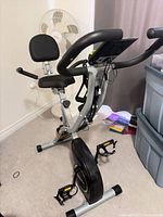 Full view of Linodiva folding exercise bike showing frame, seat, backrest, handlebars, and pedals