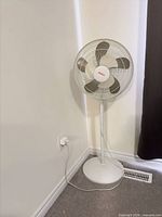 Full view of pedestal fan showing base, pole, head and power cord
