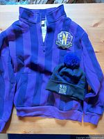 Sweater and beanie together on table