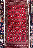 Full view of Turkman rug mat showing red field and overall design