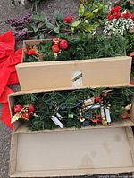 Garland sections in boxes showing ornaments and lights
