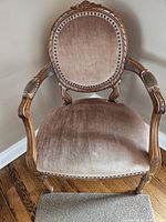 Front view of chair showing upholstery, arms and legs