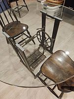 Full view showing round glass top and Singer treadle base