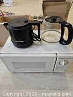 Microwave, kettle, and coffee carafe grouped