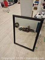 Front view of rectangular mirror leaning against wall