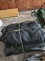 Large black mesh cover bundled with rope