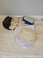 Mixed folded bedding items on floor