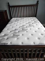 Full view of queen mattress on bed frame