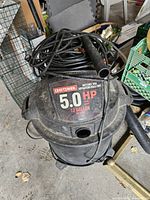 Top view of 5.0-HP 13-gallon Craftsman vacuum with cord and hose