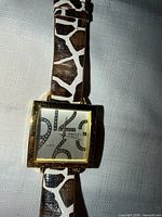 Front view of watch showing dial, case and strap pattern