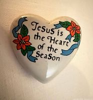 Front view of ceramic heart brooch showing text and floral design