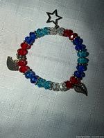 Full view of bracelet showing bead colours and charms
