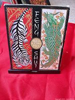 Front of boxed Feng Shui set showing tiger and dragon artwork