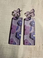 Front view of both earrings showing butterfly studs, floral-printed rectangular drops, and overall condition