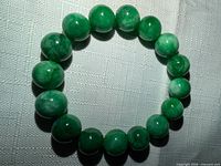 Full view of circular green stone bead stretch bracelet