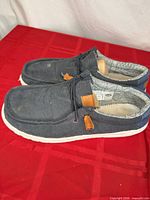 Side view of both shoes showing uppers, soles, laces