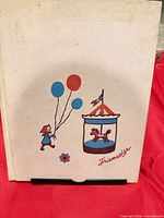 Front cover showing illustration of girl with balloons and carousel horse