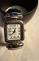 Front view showing dial, bezel and brand