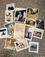 All 13 photographs laid out on carpet showing variety and condition