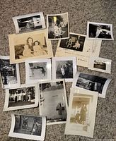 Group of approximately 14 vintage black and white photos spread out