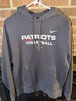 Front view showing Patriots Volleyball graphic, Nike Swoosh, pocket, drawstring hood