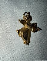 Front view of gold-tone angel brooch