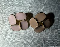 Front view of both earrings showing pale pink enamel four-petal design