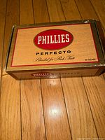 Top view showing Phillies Perfecto branding and wood-grain design