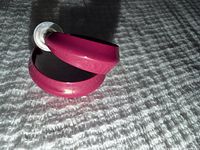 Pair of pink enamel hoop earrings standing upright showing width and enamel gloss
