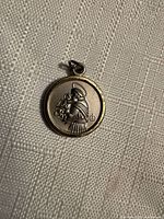 Obverse of medal showing Saint Anthony holding Infant Jesus