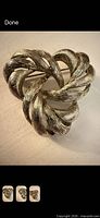 Front view of silver-tone swirl brooch