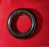 Front view showing circular shape and wood-grain look