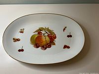 Top view of oval platter showing fruit motif and gold rim