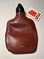 Front view of brown leather Botillo flask with tag attached