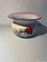 Full view of chamber pot showing rim color and floral design